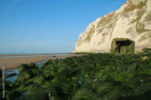 The beaches under the high white  cliffs on the shore of the Channel at Escalles in France with the ruins of the German bunkers from second world war.  photo