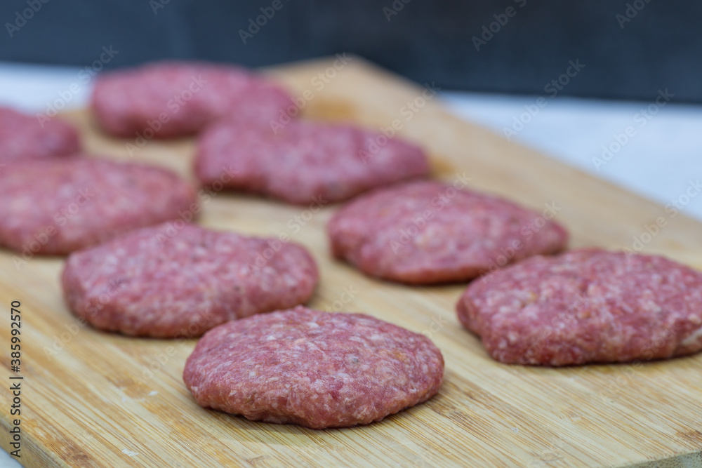 minced meat patties on a cutting board minced meat patties on a cutting board