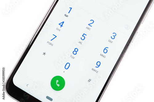 Modern smartphone screen with numbers dialing keypad in close-up on a white background photo