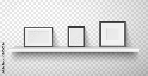 Frames, passepartout for photo, picture with white and black borders are on wall shelf.