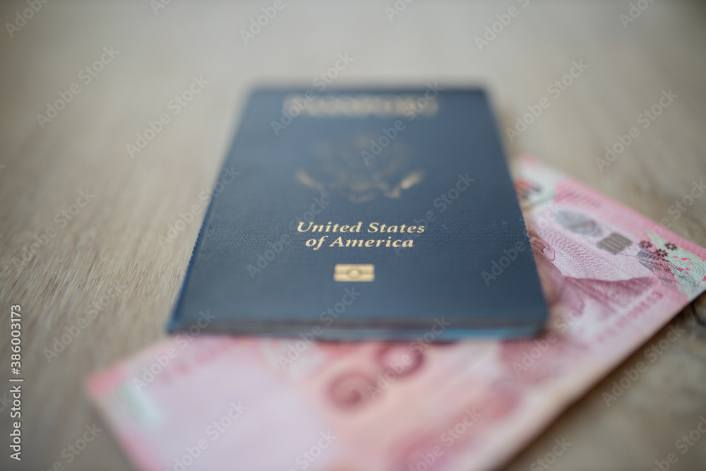 United States of America Passport with a 100 Thai Baht Bill Partially Inside United States of America Passport with a 100 Thai Baht Bill Partially Inside