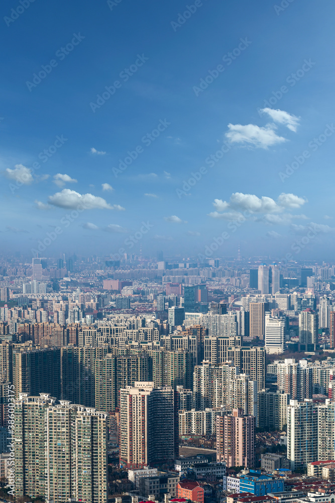 aerial view of Shanghai cityscape and modern skyscraper city in misty sky background behind pollution haze, in Shanghai, China.