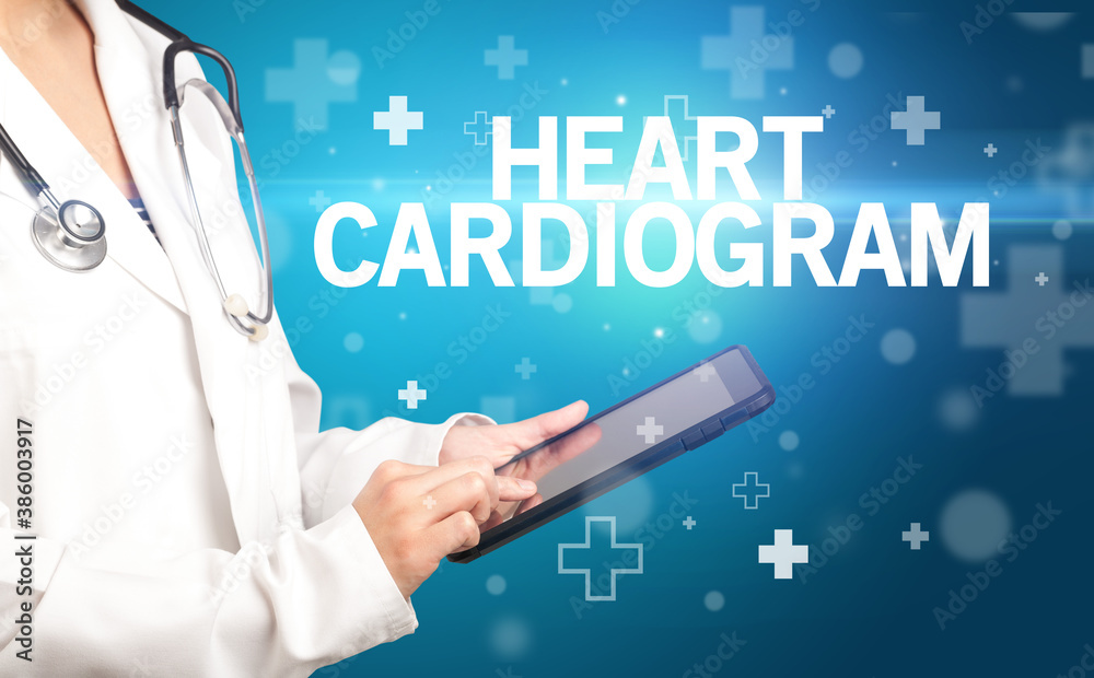 doctor writes notes on the clipboard with HEART CARDIOGRAM inscription, first aid concept doctor writes notes on the clipboard with HEART CARDIOGRAM inscription, first aid concept