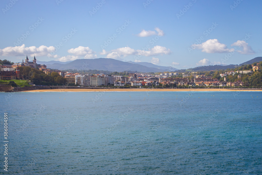 San Sebastian landmark, view from the sea. Famous beach called La Concha in San Sebastian, Spain. Scenic bay of Biscay. Aerial view of Biscayen seacoast and mountains on background. Seaside and city.