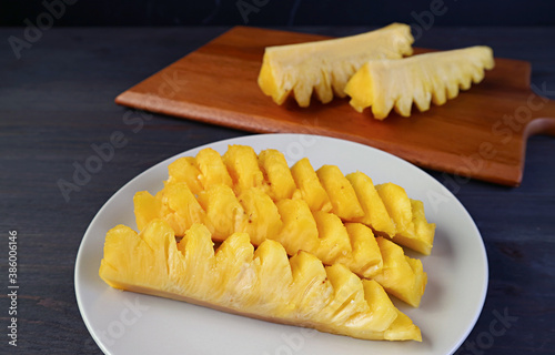 Slices of fresh ripe pineapple in a white plate ready to serve