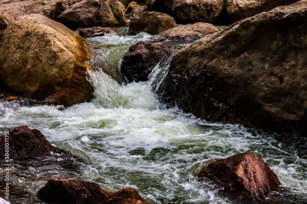 River flows over rocks in this beautiful scene River flows over rocks in this beautiful scene
