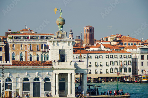 Panoramic scenic view of Venice Venezia skyline with bell towers, old historic buildings palazzi houses, basilica churches and San Marco tower and Doge palace and maritime traffic on Giudecca Canale photo