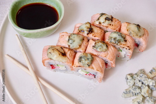 Fresh sushi rolls on a plate, top view