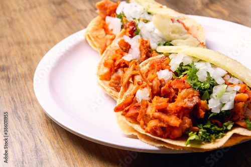 Tacos al pastor with corn tortillas. Mexican food. Mexican food concept on wooden table. Traditional Mexican food