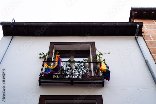 Low angle view of balcony with LGBTQ rainbow flags in Lavapies
