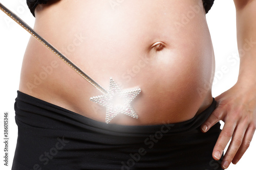 Babybauch mit Zauberstab photo