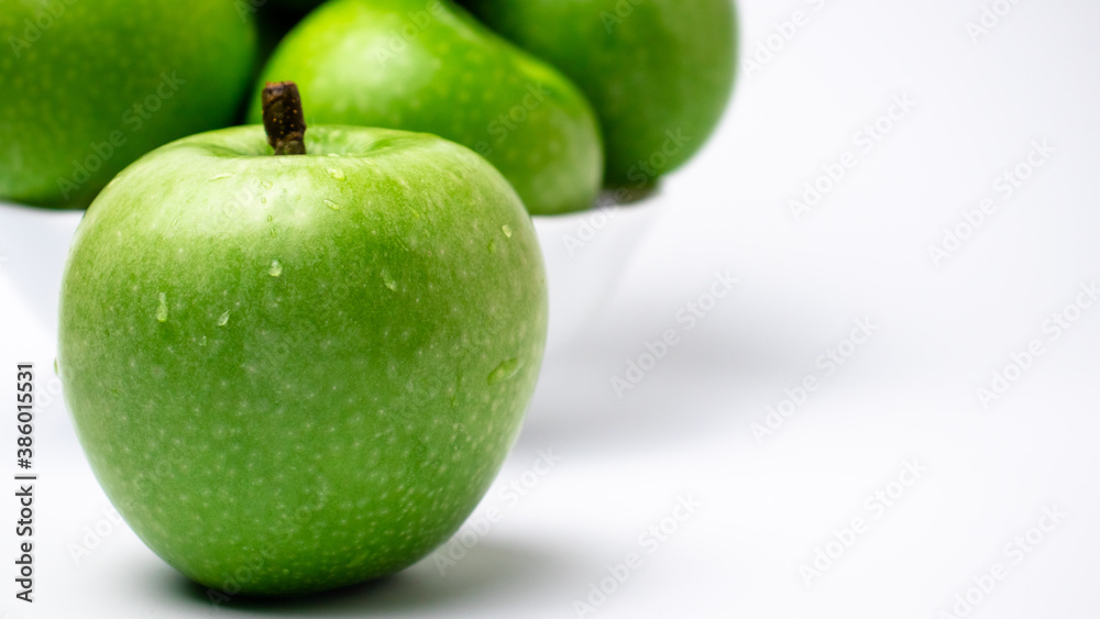 Green apple with water drops close-up. Green apple with water drops close-up.