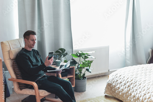 Man talking on the phone during a meeting working from home