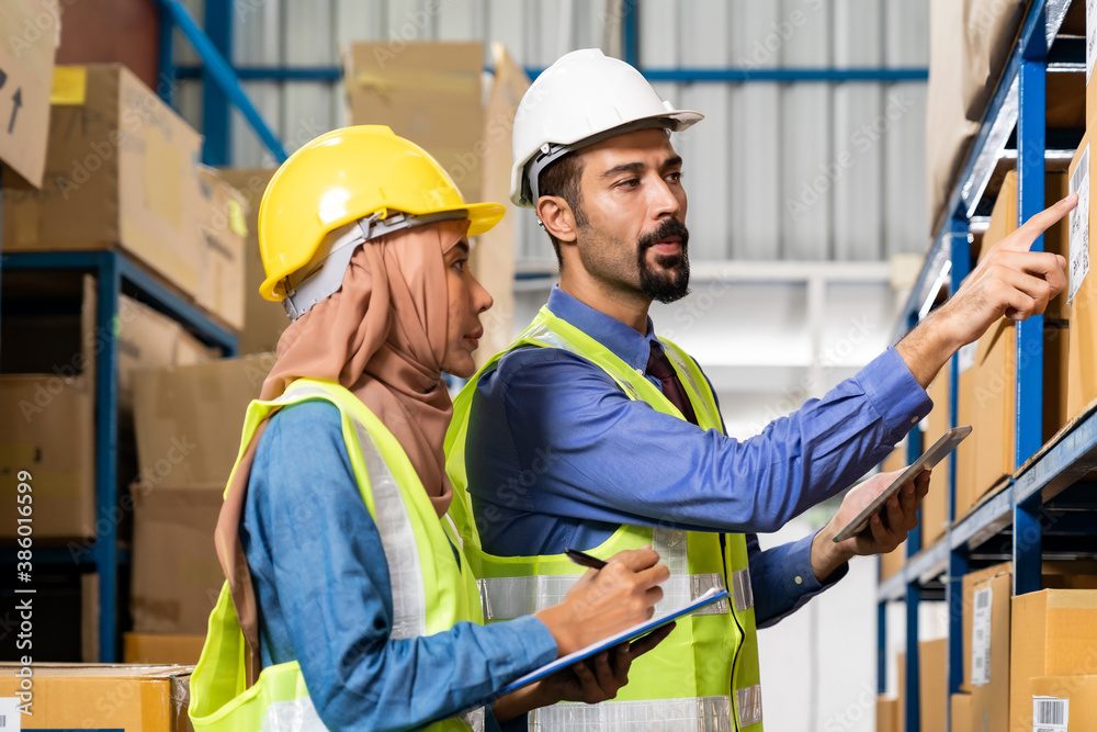 Warehouse manager talk with worker about logistic Warehouse manager talk with worker about logistic