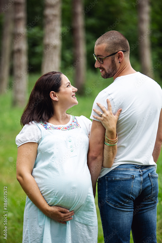 Pregnant woman with her husband in nature Pregnant woman with her husband in nature