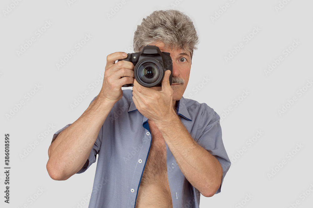 Portrait of handsome elderly man taking photo with camera isolated over grey background Portrait of handsome elderly man taking photo with camera isolated over grey background