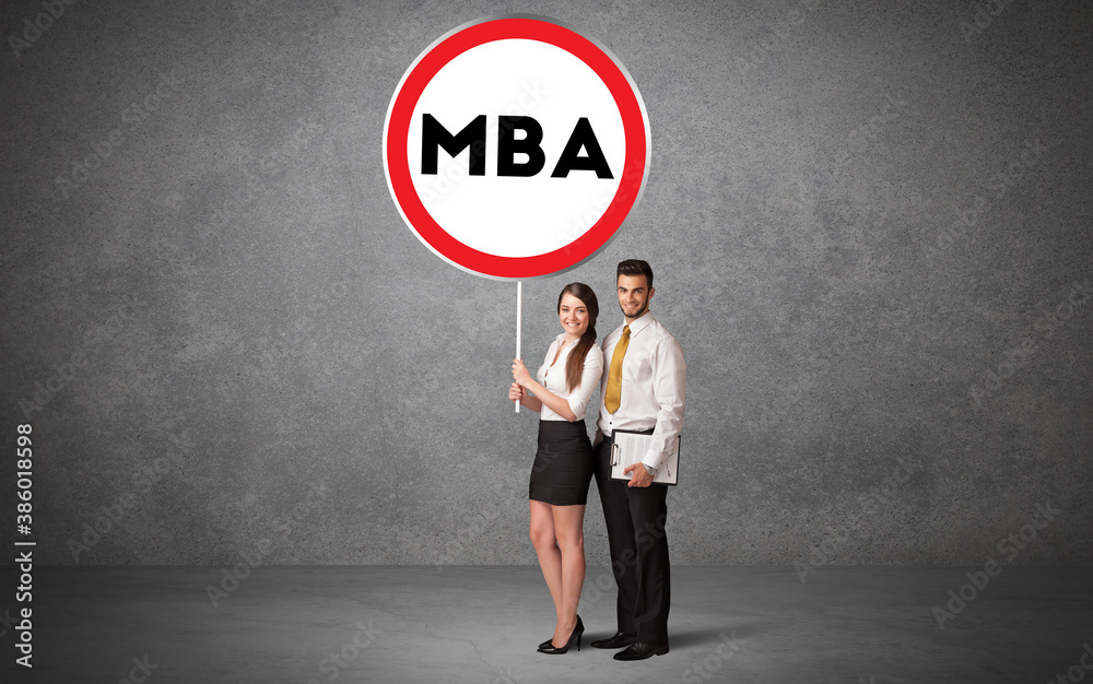 Young business person holdig traffic sign with MBA abbreviation, technology solution concept Young business person holdig traffic sign with MBA abbreviation, technology solution concept