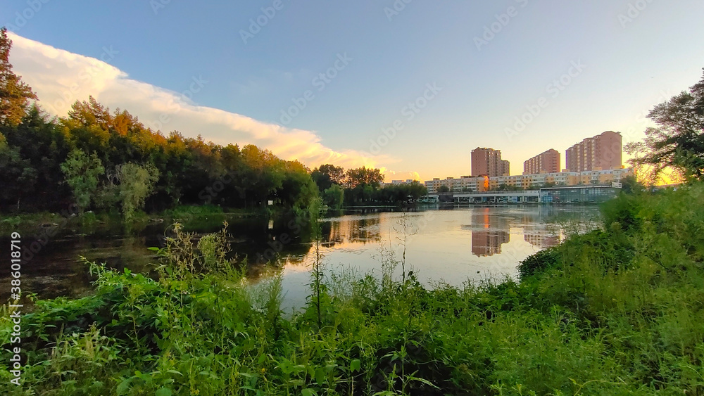 A park with pond in a city. Eco-friendly living in a city. A park with pond in a city. Eco-friendly living in a city.