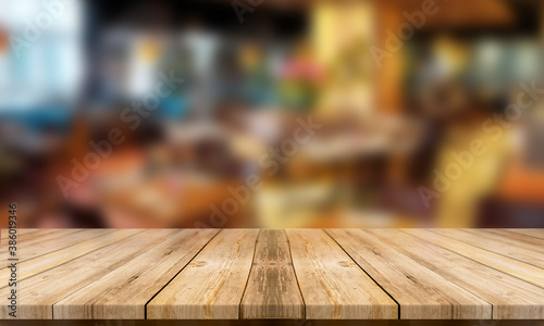 Empty table with blurred restaurant background to display your product