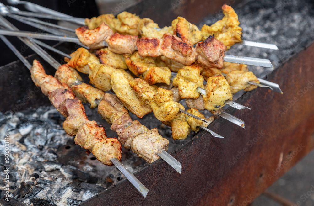 Shashlik during of cooking on the mangal over hot charcoals Shashlik during of cooking on the mangal over hot charcoals
