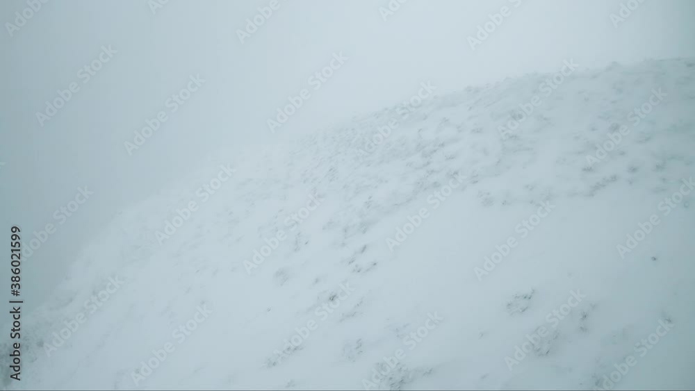 View from the top station of the cable car. The cable car is moving downward slowly. The area is covered with snow View from the top station of the cable car. The cable car is moving downward slowly. The area is covered with snow