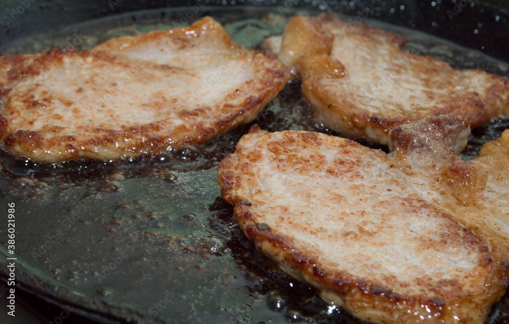 Process of cooking. Fried meat. Pork chop.