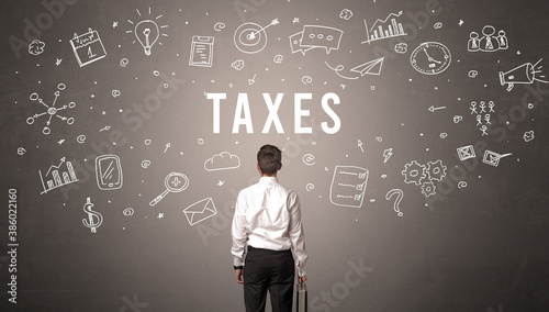 Rear view of a businessman with TAXES inscription, modern business concept © ra2 studio