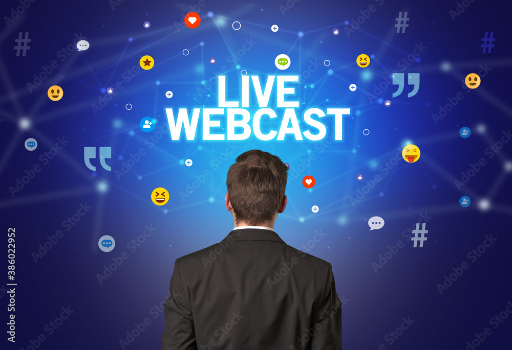 Rear view of a businessman with LIVE WEBCAST inscription, social networking concept Rear view of a businessman with LIVE WEBCAST inscription, social networking concept
