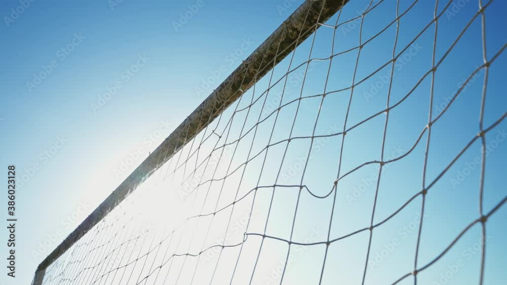 The soccer ball flies into the goal. The footballer scores a goal. Winning the championship. Football concept. Street sports in a poor area of a city or village. Training. Childhood memories The soccer ball flies into the goal. The footballer scores a goal. Winning the championship. Football concept. Street sports in a poor area of a city or village. Training. Childhood memories