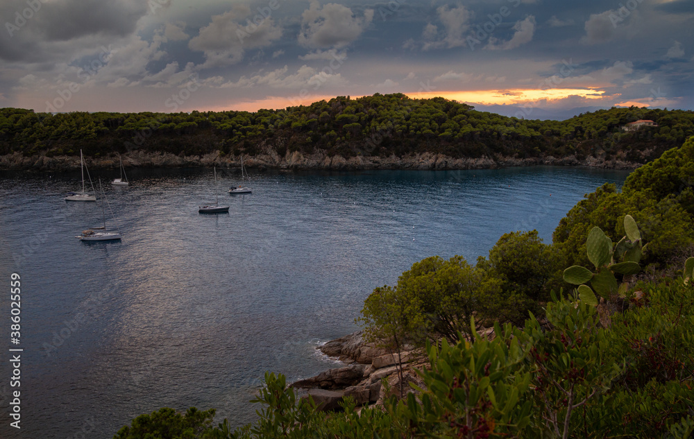 boats in evening light on sunset in the bay of Fetovaia Beach, Isola d'Elba (Elba Island), Tuscany, Italy