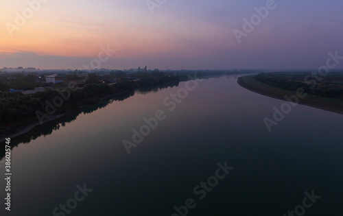 The Kura river flowing through the city of Neftechala at sunrise © alexmu