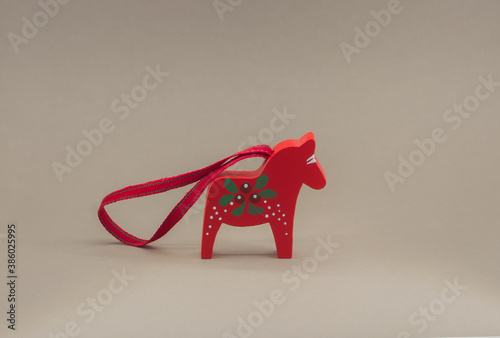 small red dalahorse key chain in light box with grey background photo
