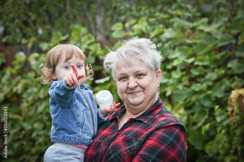 Happy Grandmother with Silver hair holding Little Cute 1 Years Old Granddaughter, October 2020, Portland, Oregon, Happy Family Concept