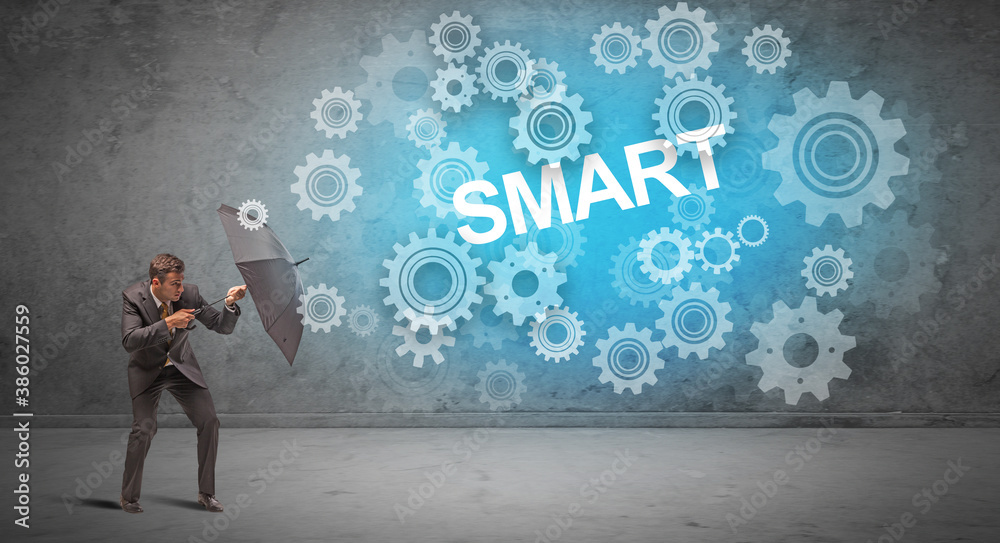 Businessman defending with umbrella from SMART inscription, technology concept Businessman defending with umbrella from SMART inscription, technology concept