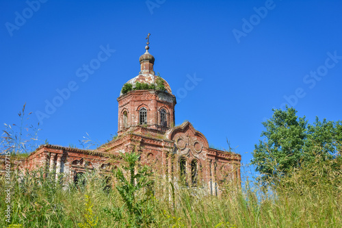 Old brick abandoned orthodox Church of the Trinity Church. abandoned Trinity Church in the village of Zasechnoye. abandoned red brick church in the thicket, abandoned temple in the field