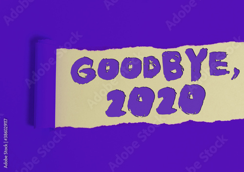 Writing note showing Goodbye 2020. Business concept for New Year Eve Milestone Last Month Celebration Transition Rolled ripped torn cardboard above a wooden classic table photo