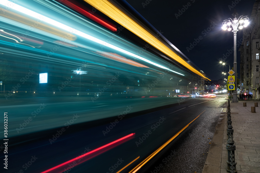 long exposure, light traces from traffic on the background of a night city