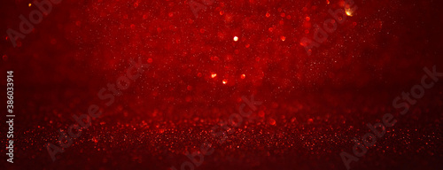 background of abstract red, gold and black glitter lights. defocused photo