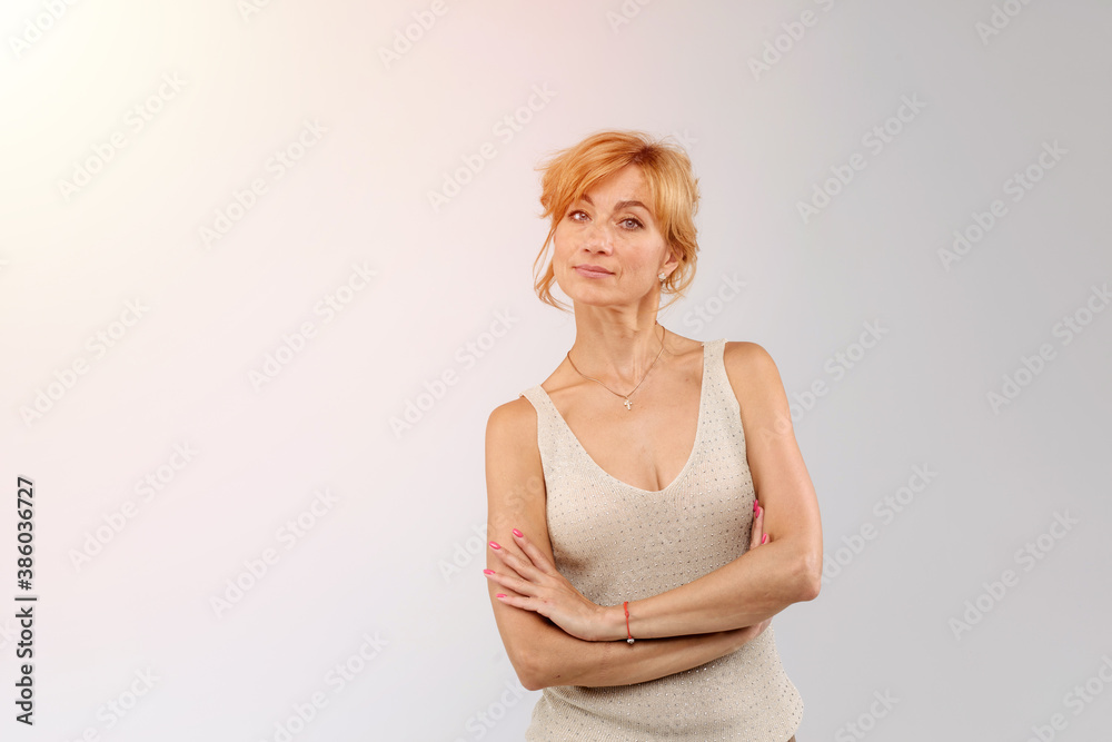 Beautiful lady posing with confidence, arms folded. Isolated on white background Beautiful lady posing with confidence, arms folded. Isolated on white background