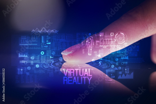 Finger touching tablet with web technology icons and VIRTUAL REALITY inscription