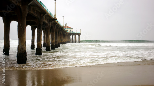 Wallpaper Mural Manhattan Beach Pier with columns sand and water in frame on gloomy day. Torontodigital.ca