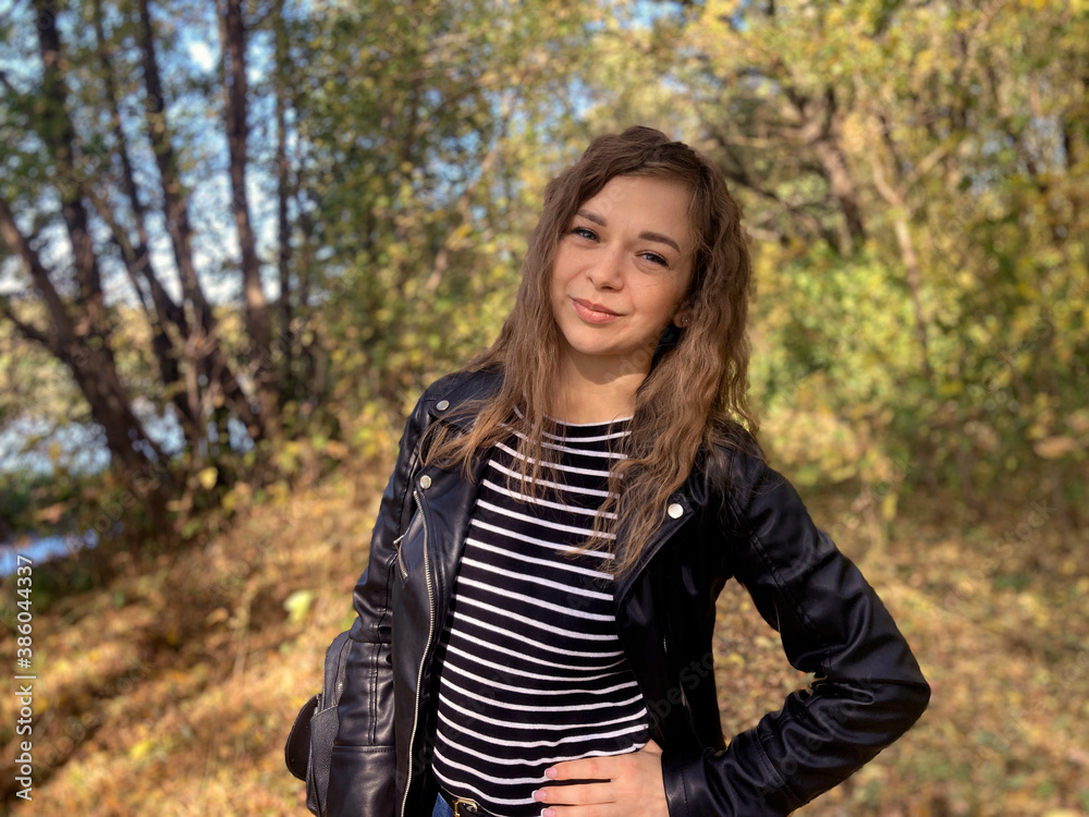 Close up of attractive young woman posing in wood. Charming female photographed on camera, standing in forest. Close up of attractive young woman posing in wood. Charming female photographed on camera, standing in forest.