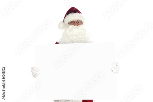 Senior man wearing a traditional Santa Claus costume holding a blank white sign ready for your copy.  Isolated on white.