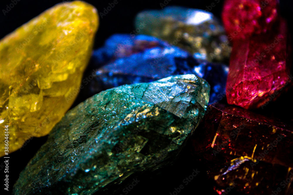 4K Assortment of glittering stones in front of black background