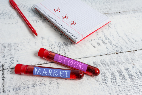 Handwriting text Stock Market. Conceptual photo Particular market where stocks and bonds are traded or exhange Extracted blood sample vial with medical accessories ready for examination photo