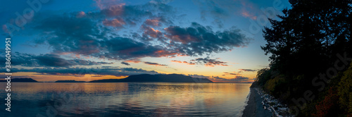 Sunset Over Orcas Island in the Salish Sea and the San Juan Island Archipelago. Beautiful and dramatic sunset with colorful clouds and a calm sea in the Pacific Northwest. © LoweStock