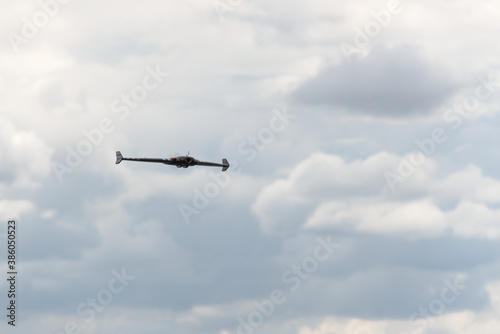 Delta remote control flying wing, front on with a cloudy background.