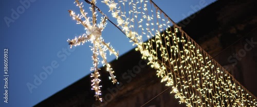 Christmas illuminated decorations on the streets of Lisbon during a holiday season. Slow motion. 