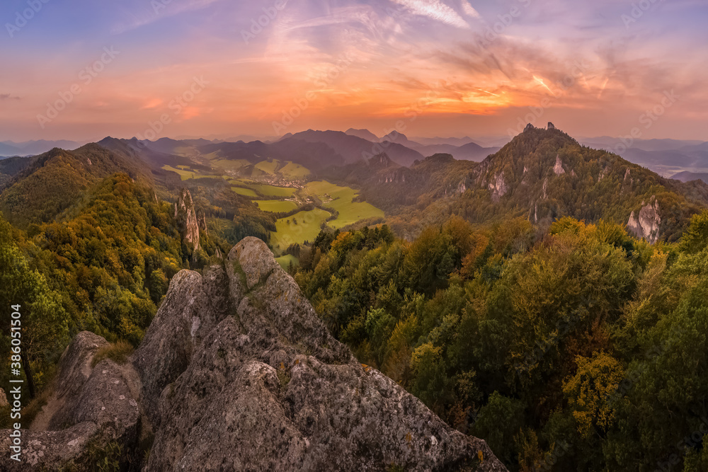 the rising sun illuminate the mountain in autumn colors