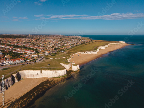 Drone aerial shot of View of sea at low tide and empty beach with Chalk Cliff Arch in Margate, England photo